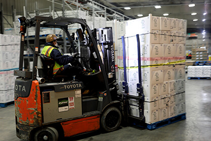 Forklift lifting boxes