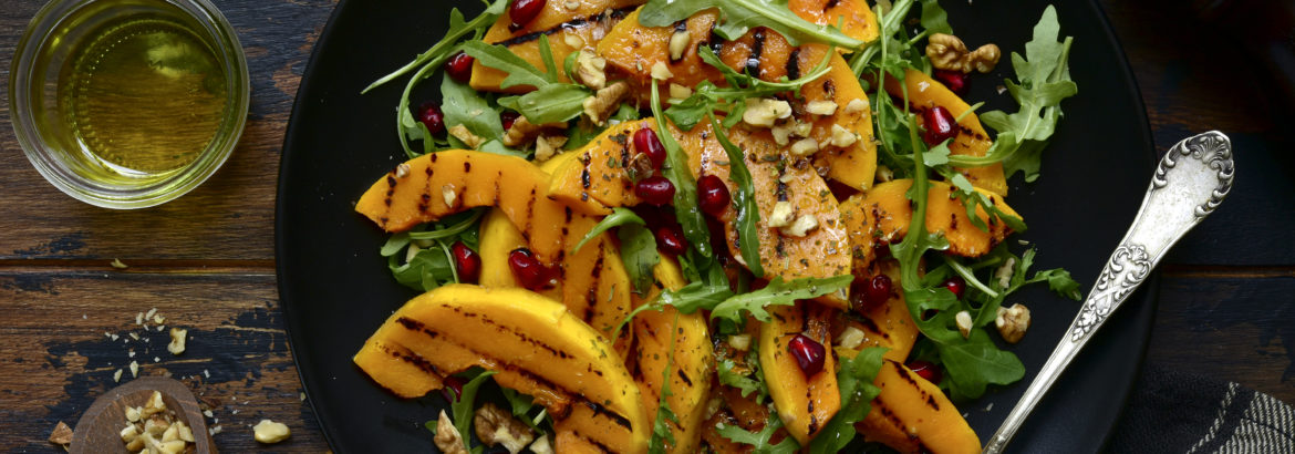 Grilled pumpking warm salad with arugula, walnuts and pomegranate seeds