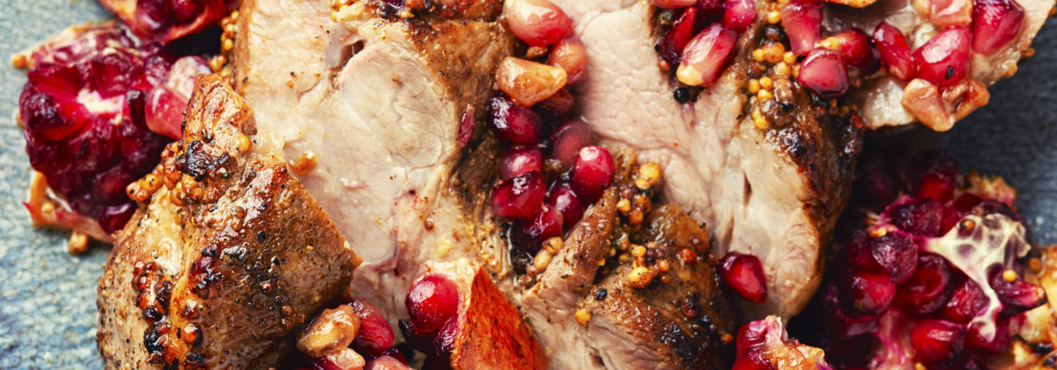 Pork meat fried with pomegranate, close up