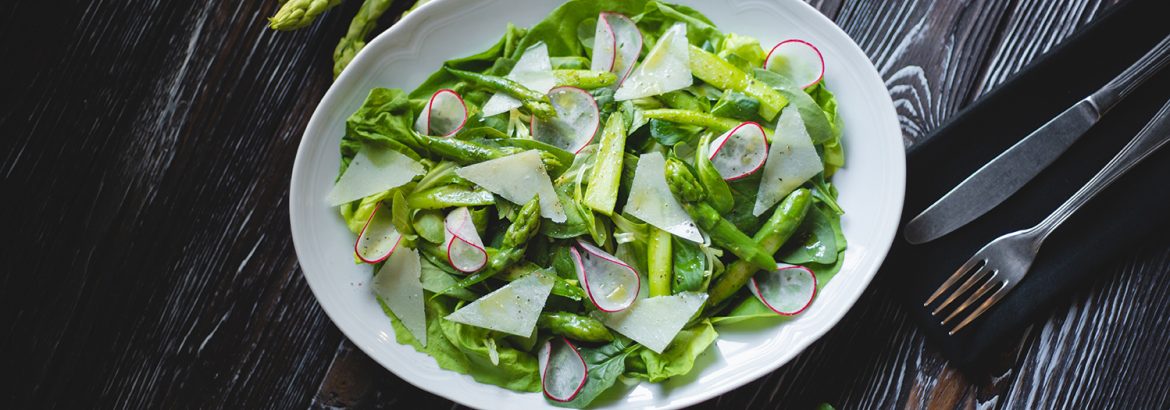 Food photography. Green salad with fresh vegetables, asparagus and radishes