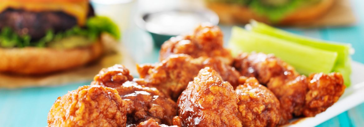 boneless barbecue chicken with burgers and beer in the background