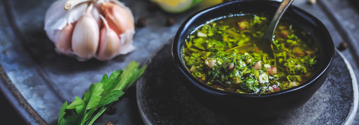 Chimichurri verde - traditional Argentine condiment, made from finely chopped parsley, minced garlic, olive oil, oregano, and wine vinegar