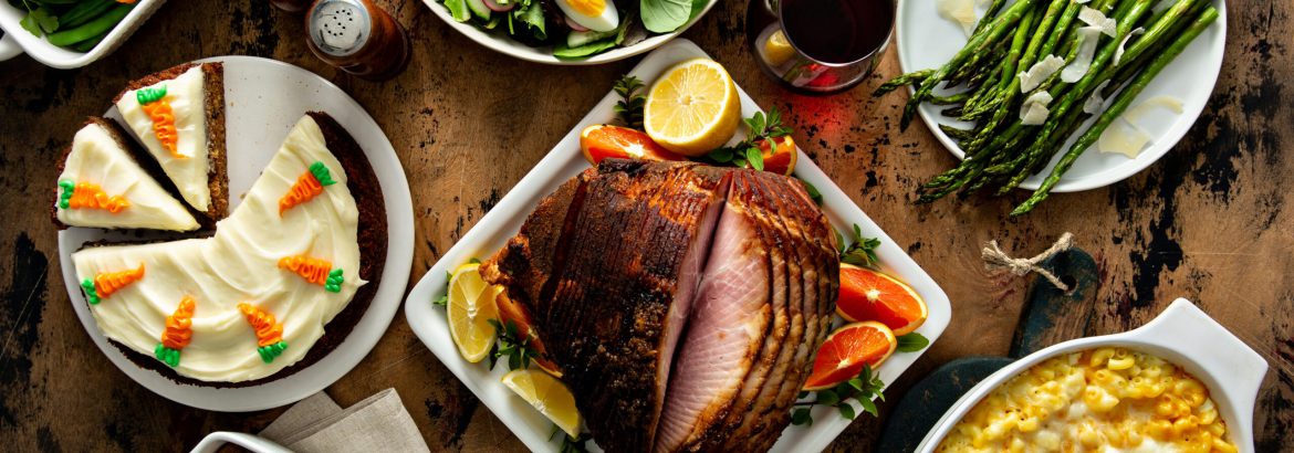 Easter dinner table with ham, asparagus and carrot cake