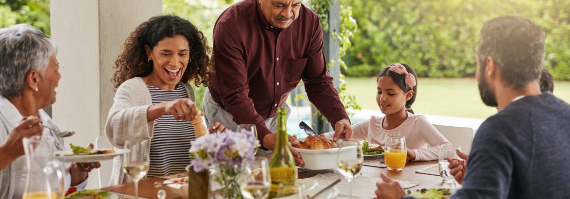Shot of a carefree elderly man cutting up a chicken to serve to the rest of the family at lunch during the day