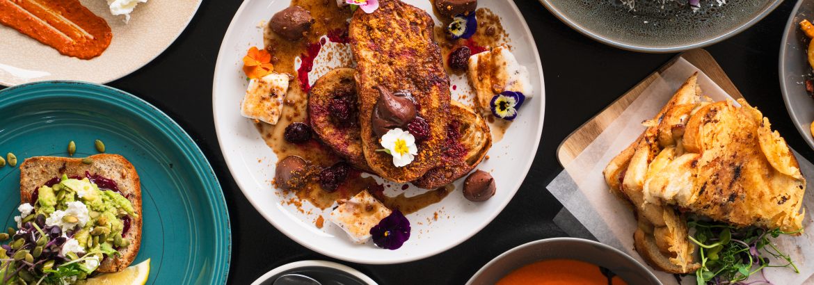 A colorful assortment of dishes arranged on a table, offering a visually inviting and appetizing spread for any occasion.