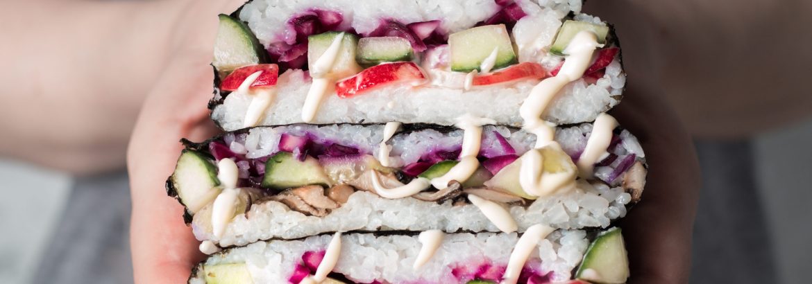 Vegan sushi sandwich onigirazu with mushrooms and vegetables.Healthy dinner recipe and idea. Colorful japan big roll sandwich onigirazu with red cabbage,radish,cucumber,mushrooms.Trend food.Copy space