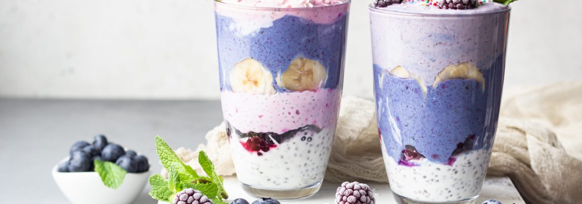 Detox layered smoothie made of different berries, fruits and chia pudding in glasses. Vegan dessert. Healthy vegetarian breakfast, dieting, weight loss food.