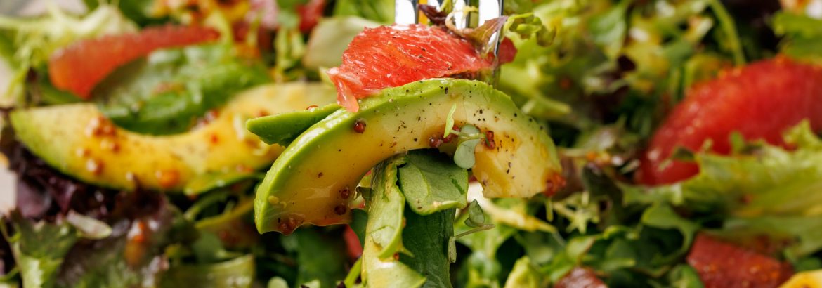 Fresh salad with grapefruit, avocado and pomegranate seeds