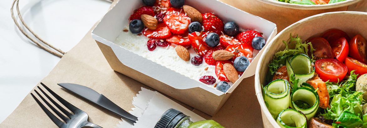 Healthy meal slimming diet plan daily ready menu background, organic fresh dishes and smoothie, fork knife on paper eco bag as food delivery courier service at home in office concept, close up view.